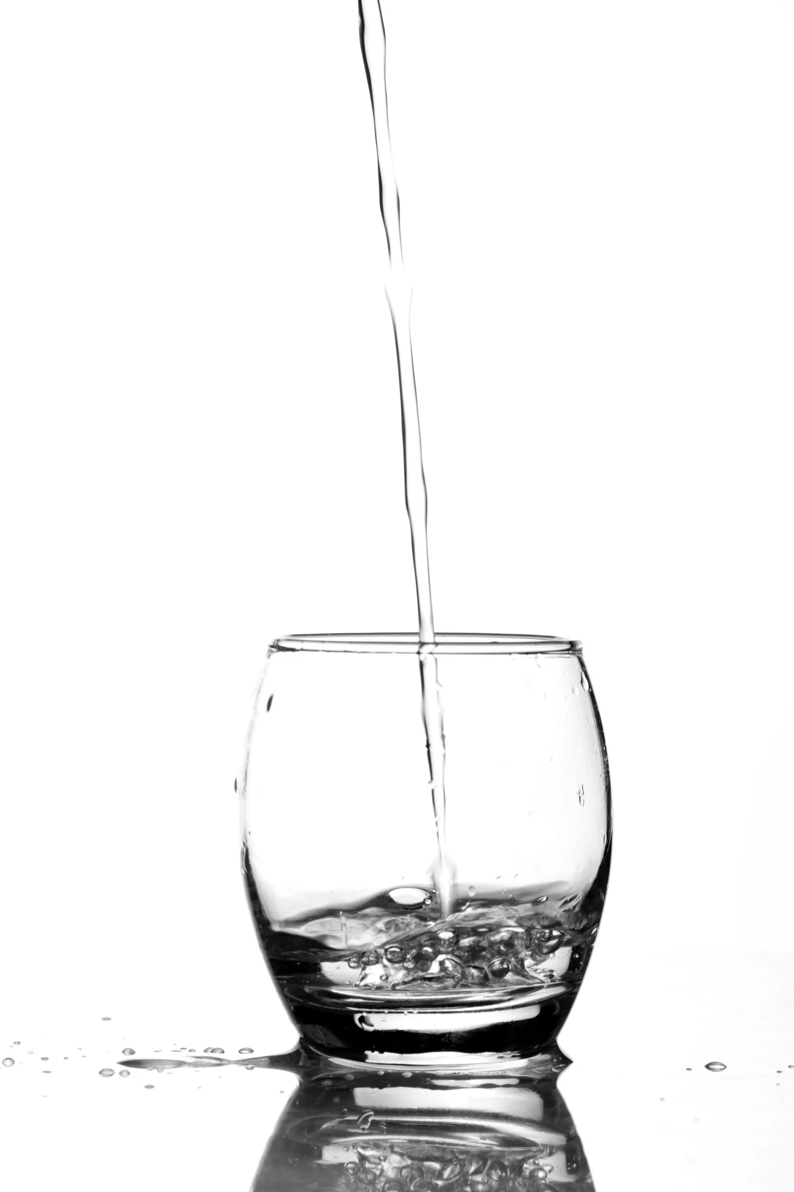 Close-up of clear water pouring into a glass